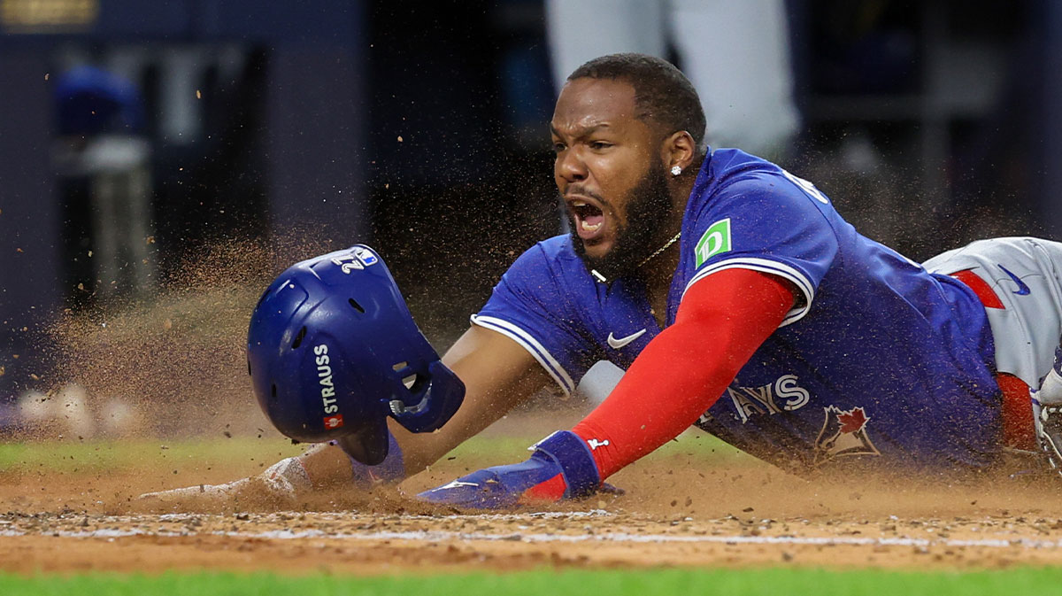 Toronto Blue Jays first basemen Vladimir Guerrero Jr. (27) slides into home plate to score in the third inning against the New York Yankees during game three of the ALDS round for the 2025 MLB playoffs at Yankee Stadium.