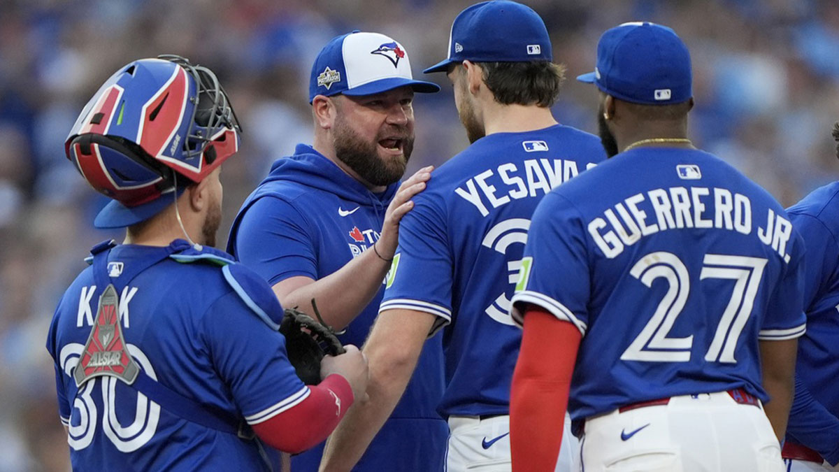 Toronto Blue Jays manager John Schneider (14) talks to pitcher Trey Yesavage (39) in the sixth inning against the New York Yankees during game two of the ALDS round for the 2025 MLB playoffs at Rogers Centre.