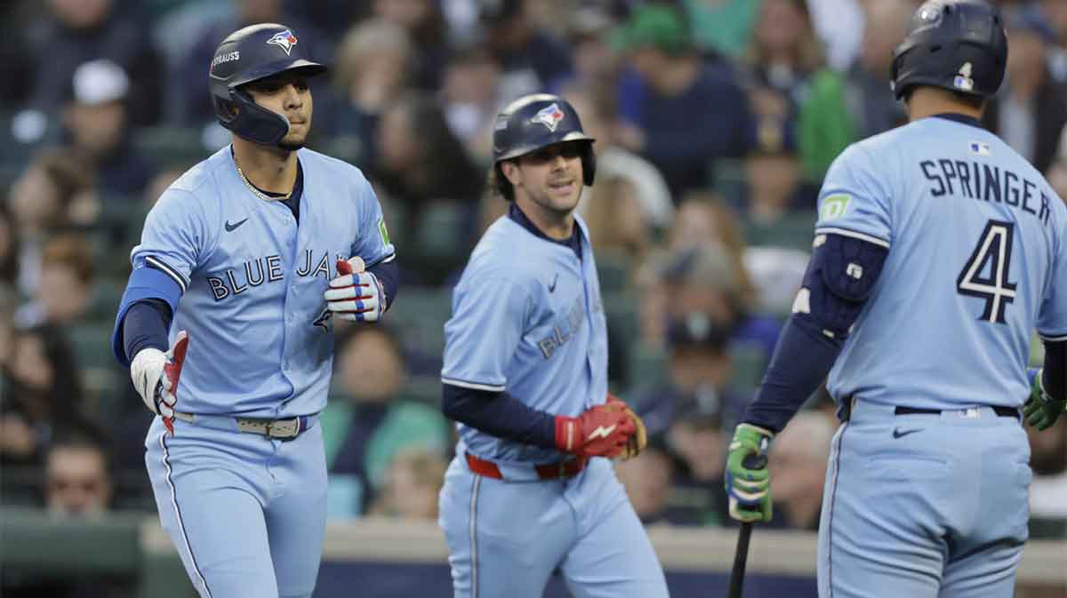 Oct 15, 2025; Seattle, Washington, USA; Toronto Blue Jays second baseman Andres Gimenez celebrates with designated hitter George Springer (4) after hitting a two-run home run in the third inning against the Seattle Mariners during game three of the ALCS round for the 2025 MLB playoffs at T-Mobile Park. Mandatory Credit: John Froschauer-Imagn Images