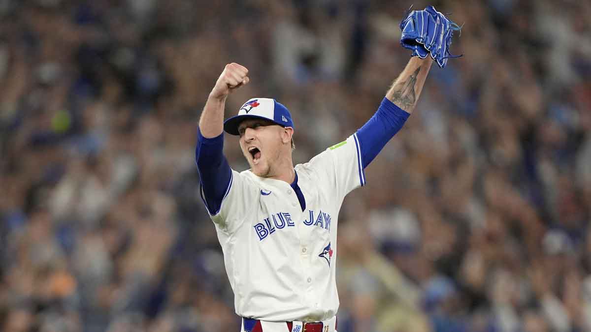 Blue Jays pitcher Jeff Hoffman (23) reacts after defeating
