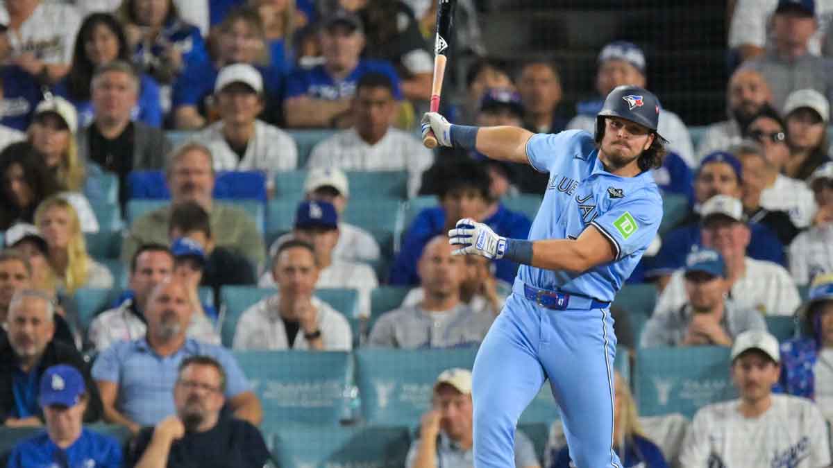 Toronto Blue Jays right fielder Addison Barger (47) hits an RBI single during the seventh inning against the Los Angeles Dodgers during game four of the 2025 MLB World Series at Dodger Stadium.