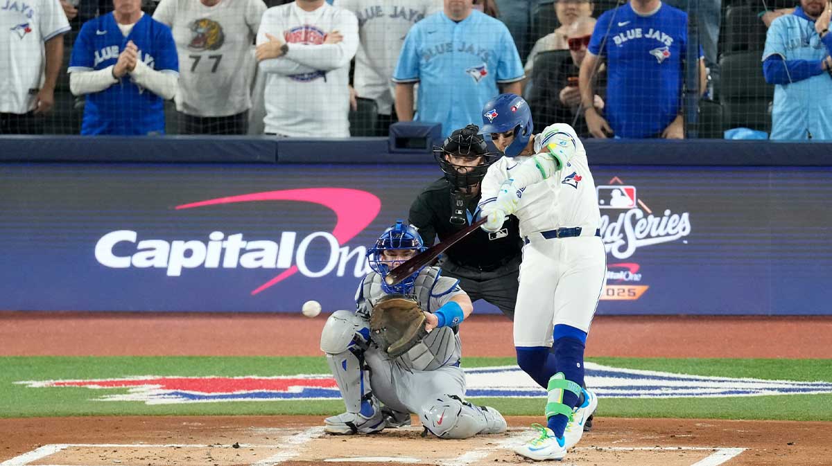 Toronto Blue Jays second baseman Bo Bichette (11) hits a single against the Los Angeles Dodgers in the first inning during game one of the 2025 MLB World Series at Rogers Centre.