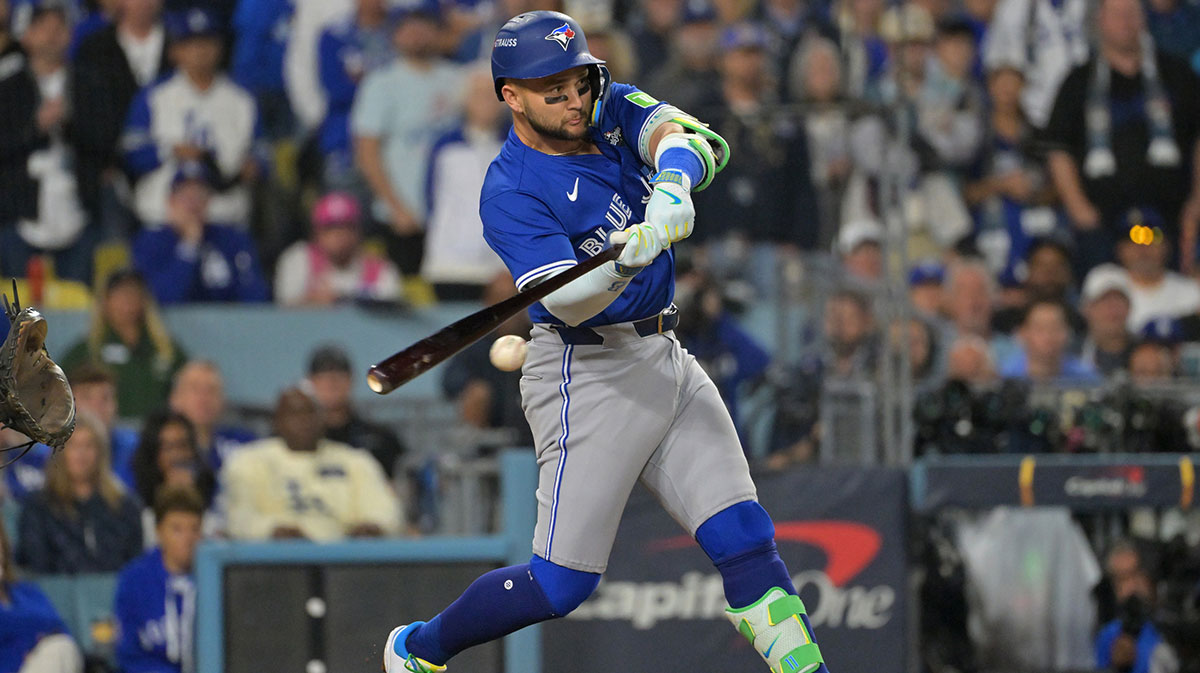 Toronto Blue Jays second baseman Bo Bichette (11) hits an RBI single against the Los Angeles Dodgers in the seventh inning during game three of the 2025 MLB World Series at Dodger Stadium.