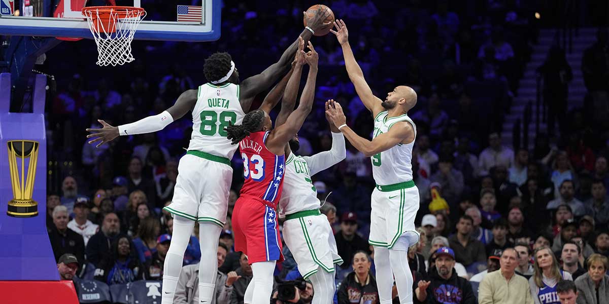 Boston Celtics center Neemias Queta (88) jumps for a rebound with forward Jaylen Brown (7) and guard Derrick White (9) against Philadelphia 76ers forward Jabari Walker (33) in the first quarter at Xfinity Mobile Arena.