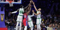 Boston Celtics center Neemias Queta (88) jumps for a rebound with forward Jaylen Brown (7) and guard Derrick White (9) against Philadelphia 76ers forward Jabari Walker (33) in the first quarter at Xfinity Mobile Arena.
