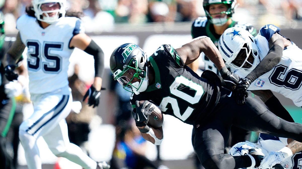 New York Jets running back Breece Hall (20), is tackled by the Dallas defense, Sunday, October 5, 2025.