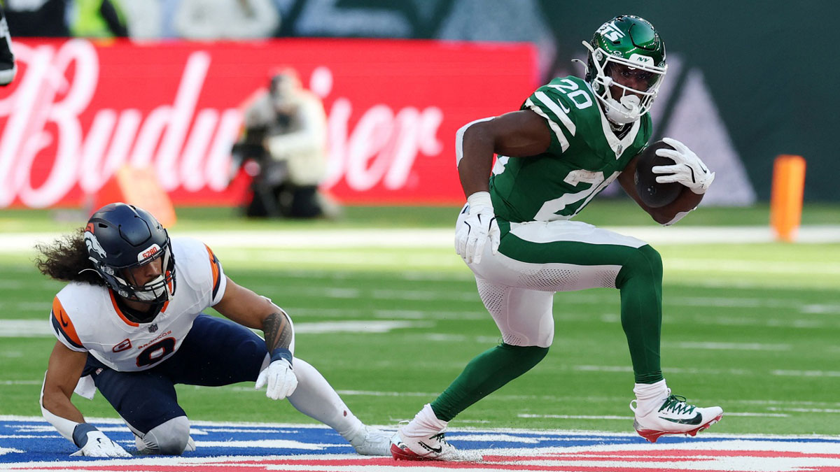 New York Jets running back Breece Hall (20) runs the ball against the Denver Broncos during an NFL International Series game at Tottenham Hotspur Stadium