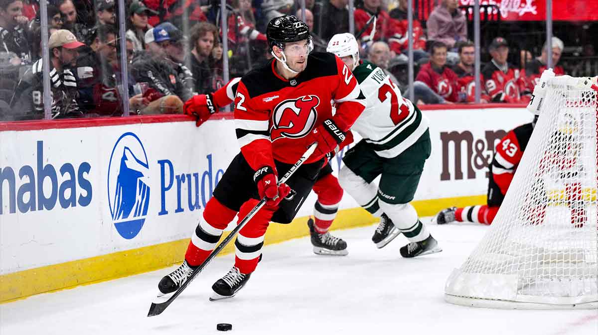 New Jersey Devils defenseman Brett Pesce (22) skates with the puck past Minnesota Wild right wing Danila Yurov (22) during the first period at Prudential Center.