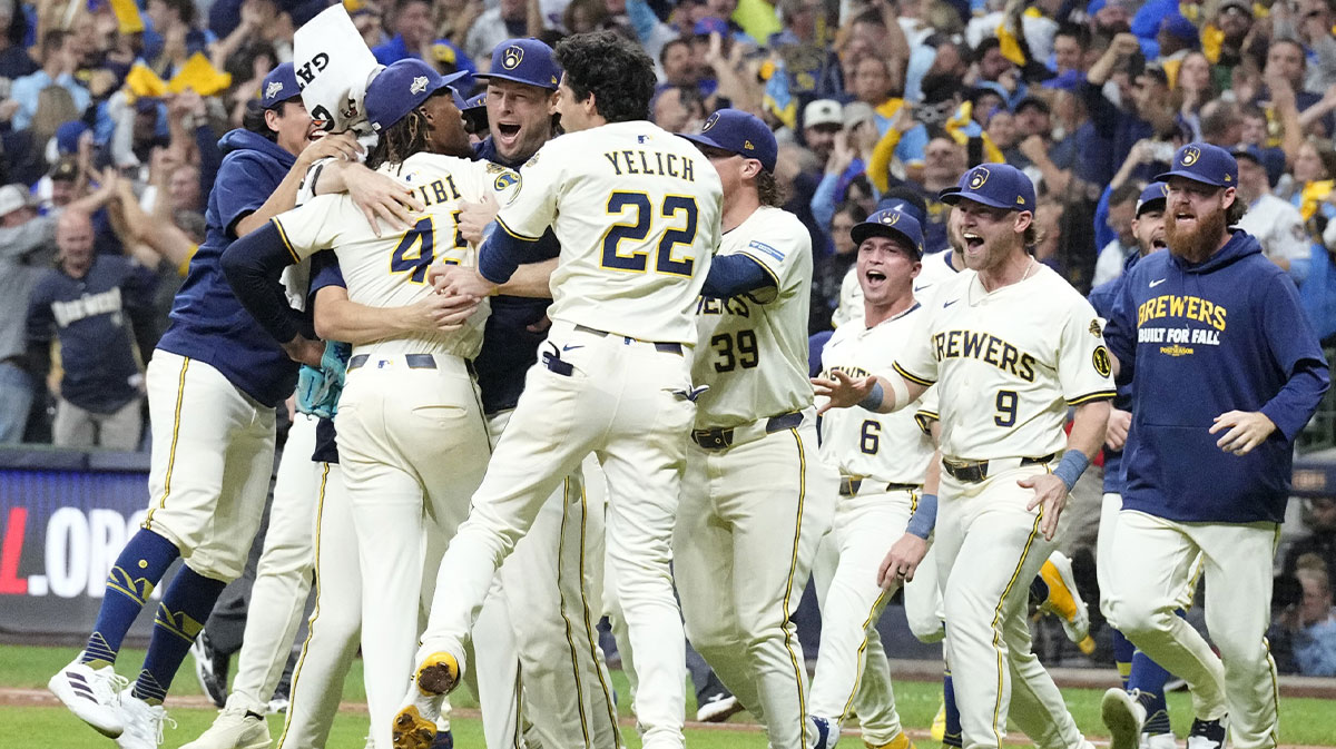Milwaukee Brewers left fielder Christian Yelich (22) and pitcher Abner Uribe (45) and pitcher Trevor Megill (29) and pitcher Chad Patrick (39) and teammates celebrate after defeating the Chicago Cubs during game five of the NLDS round for the 2025 MLB playoffs at American Family Field.
