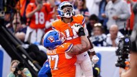 Denver Broncos wide receiver Troy Franklin (11) celebrates with guard Quinn Meinerz (77) after scoring touchdown against the Dallas Cowboys in the fourth quarter at Empower Field at Mile High.