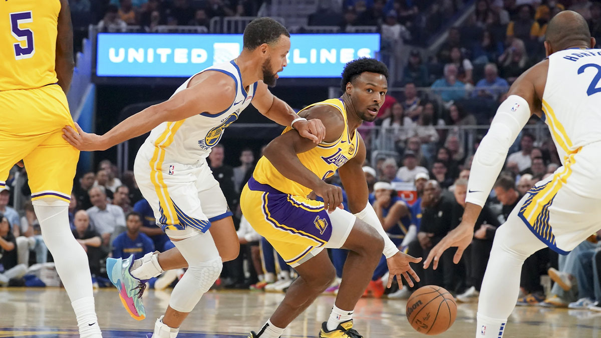 Los Angeles Lakers guard Bronny James (9) dribbles upcourt against Golden State Warriors guard Stephen Curry (30) in the first quarter at Chase Center.