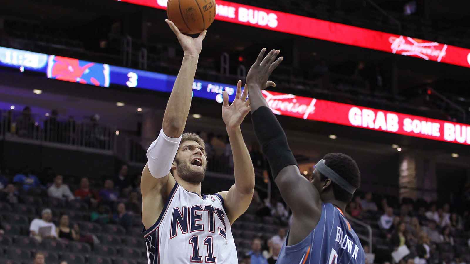 New Jersey Nets center Brook Lopez (11) hits a shot over Charlotte Bobcats center Kwame Brown (54) during the first half at the Prudential Center.