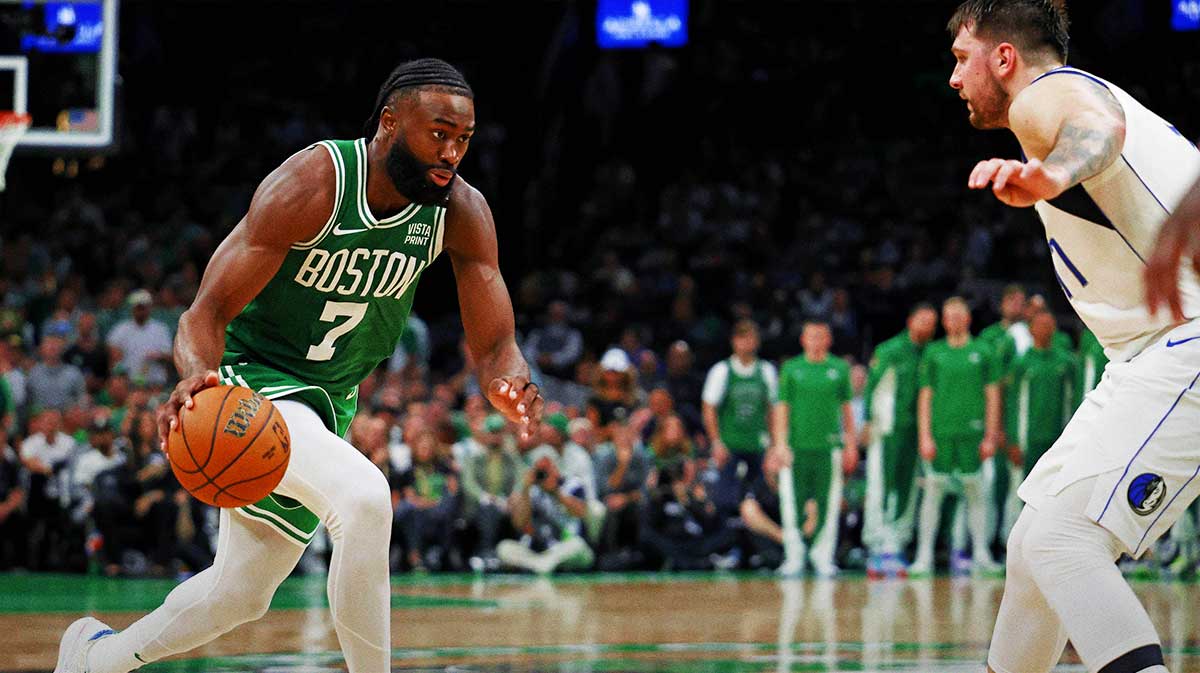 Boston Celtics guard Jaylen Brown (7) drives to the basket against Dallas Mavericks guard Luka Doncic (77) in game five of the 2024 NBA Finals at TD Garden.