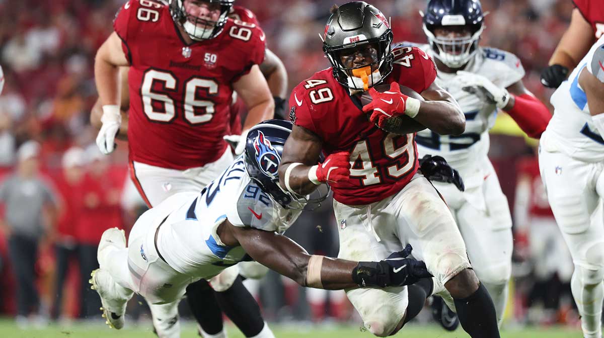 Tampa Bay Buccaneers running back Owen Wright (49) runs with the ball as Tennessee Titans linebacker Jaylen Harrell (92) defends during the second half at Raymond James Stadium.