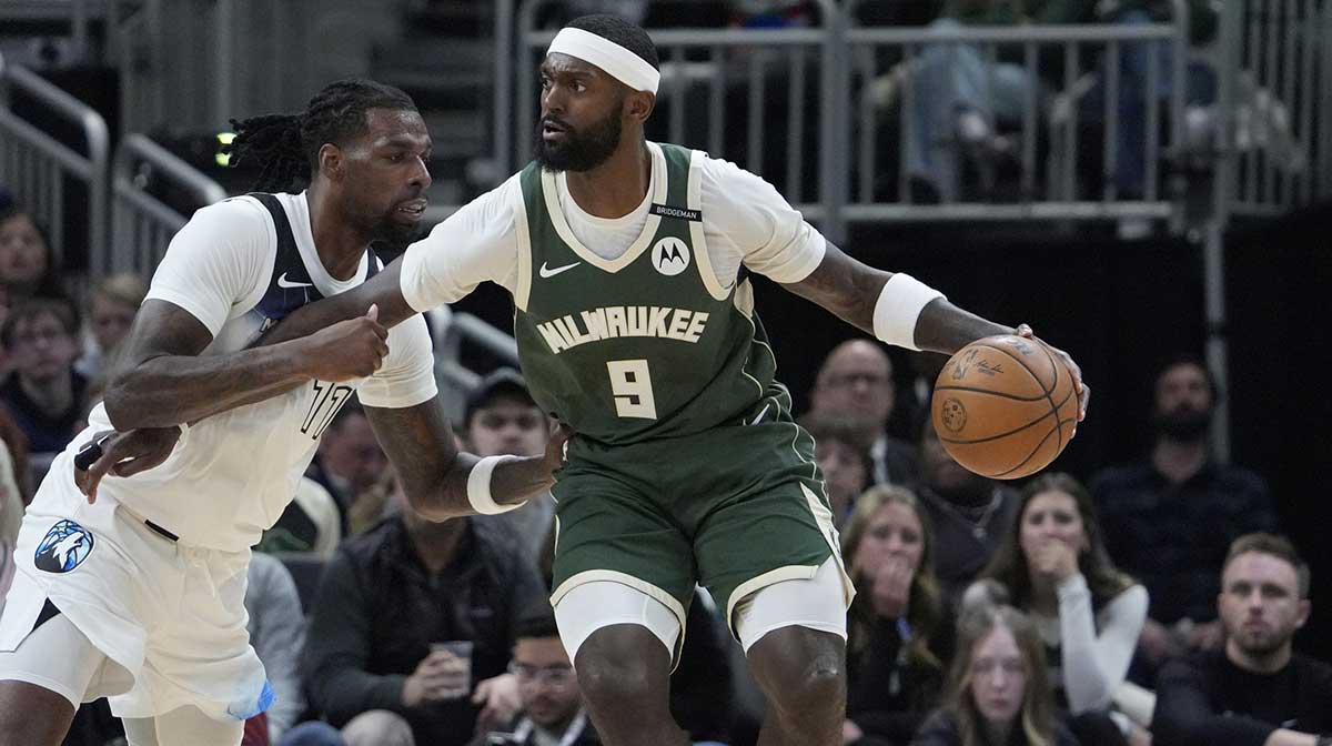 Milwaukee Bucks forward Bobby Portis (9) drives against Minnesota Timberwolves center Naz Reid (11) in the first half at Fiserv Forum.