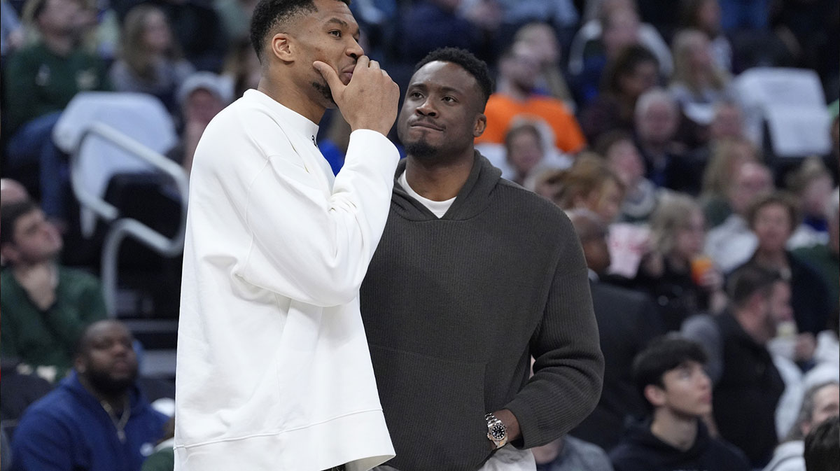 Bucks forward Giannis Antetokounmpo (34) and his brother Milwaukee Bucks forward Thanasis Antetokounmpo talks during a time out against the Detroit Pistons in the second half at Fiserv Forum with Bucks' Bobby Portis in the background