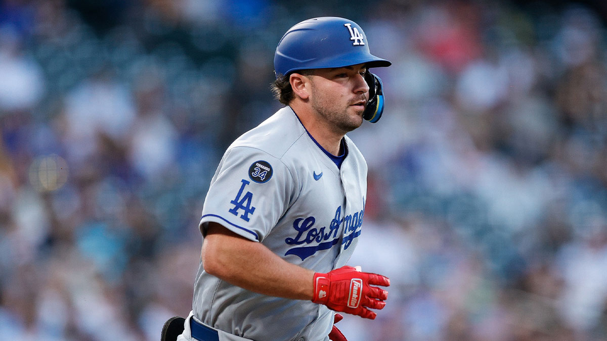 Los Angeles Dodgers third baseman Buddy Kennedy (46) runs to first on an RBI single advancing to second in the third inning against the Colorado Rockies at Coors Field.