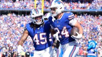 Buffalo Bills safety Cole Bishop (24) and outside linebacker Shaq Thompson (45) celebrate after intercepting a pass intended for New Orleans Saints quarterback Spencer Rattler (2) during the second quarter at Highmark Stadium.