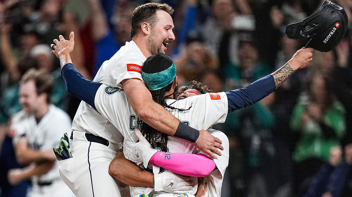 From left, Seattle Mariners catcher Cal Raleigh (29), shortstop J.P. Crawford (3) and first baseman Josh Naylor (12) celebrate 3-2 win over Detroit Tigers after 15 innings at ALDS Game 5 at T-Mobile Park in Seattle on Friday, Oct. 10, 2025.