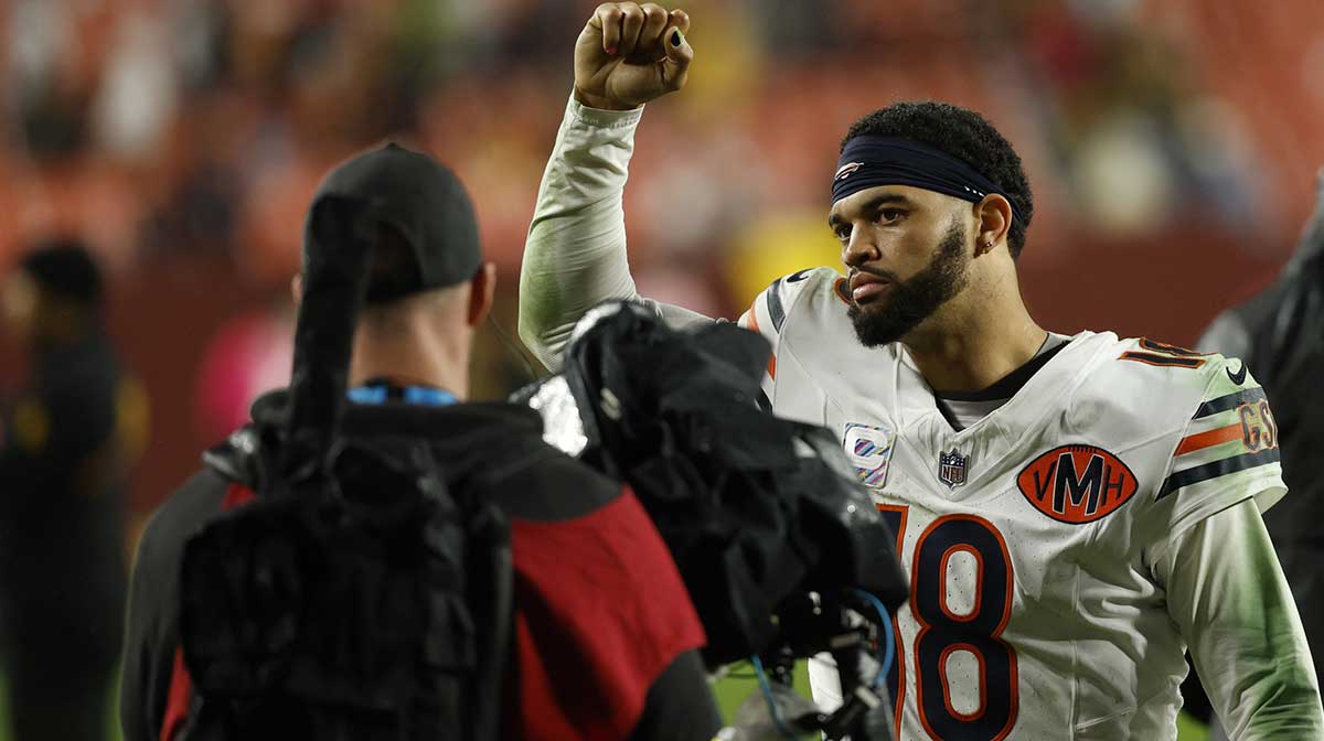 Chicago Bears quarterback Caleb Williams (18) celebrates while leaving the field after the game against the Washington Commanders at Northwest Stadium.