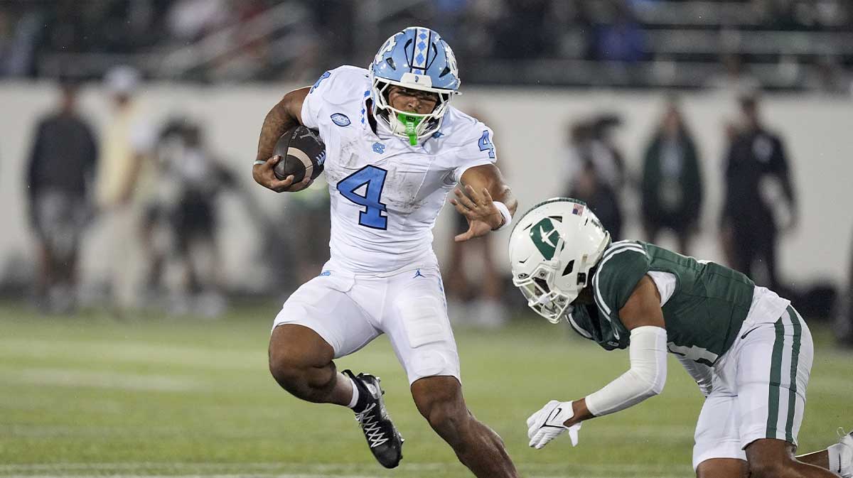 North Carolina Tar Heels running back Caleb Hood (4) tries to avoid Charlotte 49ers defensive back Gavin Shipman (4) during the second half at Jerry Richardson Stadium.