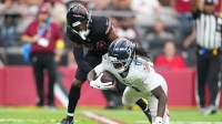 Tennessee Titans wide receiver Calvin Ridley (0) dives for yardage with Arizona Cardinals safety Jalen Thompson (34) defending during the fourth quarter at State Farm Stadium.