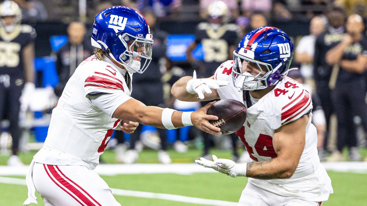 New York Giants quarterback Jaxson Dart (6) hands off to running back Cam Skattebo (44) during the first half at Caesars Superdome.