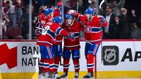 Montreal Canadiens right wing Cole Caufield (13) celebrates his goal against the Nashville Predators with his teammates during the third period at Bell Centre.