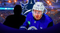 Quinn Hughes with a mystery player, canucks logo in the background