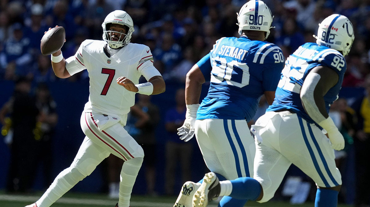 Arizona Cardinals quarterback Jacoby Brissett (7) looks to throw while Indianapolis Colts defensive tackle Grover Stewart (90) and defensive tackle Neville Gallimore (92) attempt to bring him down during a game on Sunday, Oct. 12, 2025, at Lucas Oil Stadium in Indianapolis. The Colts defeated the Cardinals 31-27.