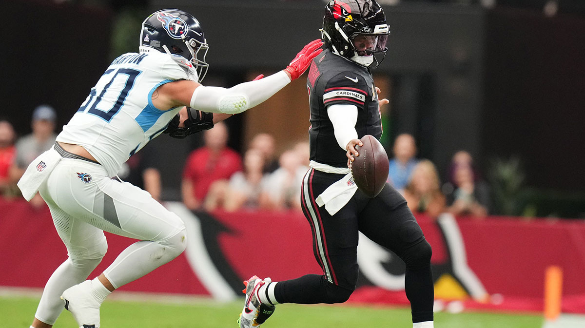 Arizona Cardinals quarterback Kyler Murray (1) scrambles for a first down as Tennessee Titans linebacker Cody Barton (50) closes in at State Farm Stadium in Glendale on Oct. 5, 2025.