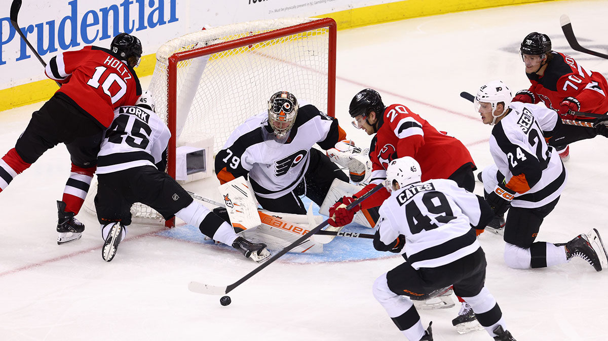 New Jersey Devils center Michael McLeod (20) plays the puck after a save by Philadelphia Flyers goaltender Carter Hart (79) during the third period at Prudential Center.