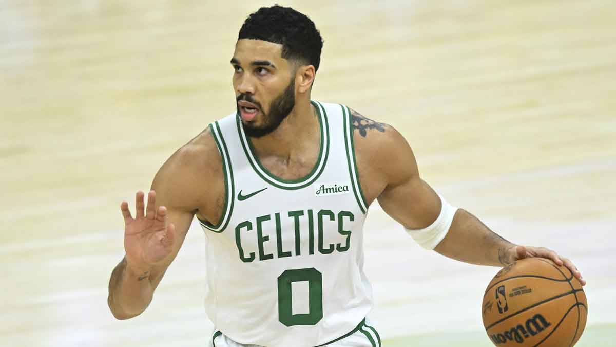 Boston Celtics forward Jayson Tatum (0) dribbles up court in the first quarter against the Cleveland Cavaliers at Rocket Mortgage FieldHouse.