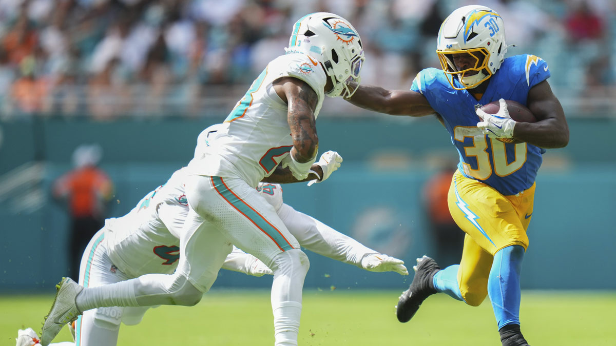 Miami Dolphins cornerback Jack Jones (23) tackles Los Angeles Chargers running back Kimani Vidal (30) during the fourth quarter at Hard Rock Stadium