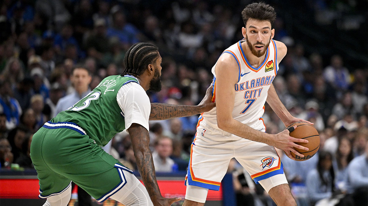Oklahoma City Thunder center Chet Holmgren (7) looks to move the ball past Dallas Mavericks forward Naji Marshall (13) during the second quarter at the American Airlines Center.