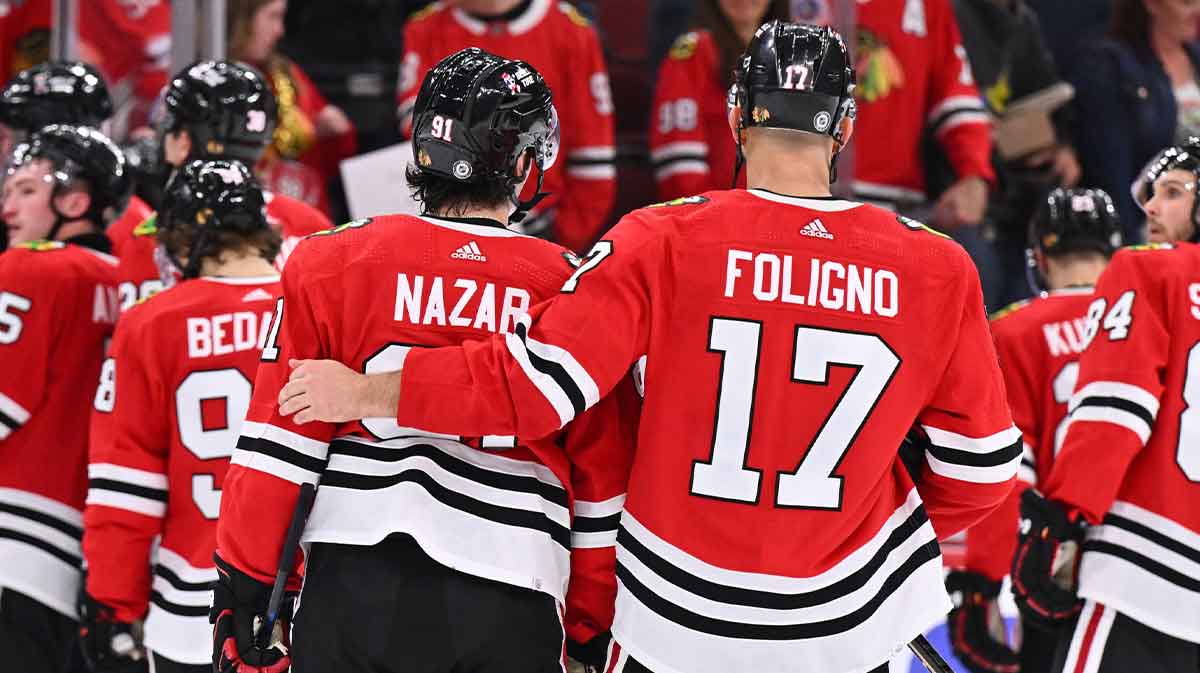 Chicago Blackhawks forward Nick Foligno (17) puts his arm around forward Frank Nazar (91) after their game against the Carolina Hurricanes at United Center.