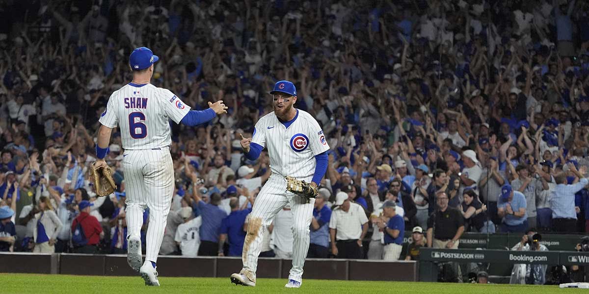 Chicago Cubs first baseman Michael Busch (29) and third baseman Matt Shaw (6) celebrate defeating the San Diego Padres during game three of the Wildcard round for the 2025 MLB playoffs at Wrigley Field.