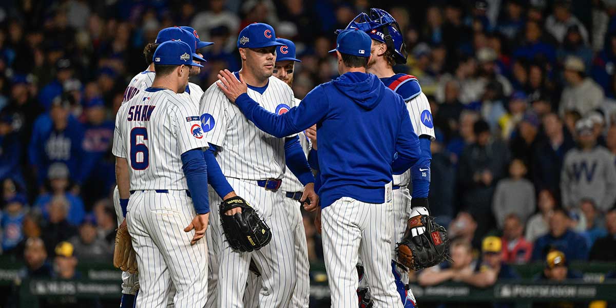 Chicago Cubs manager Craig Counsell (11) takes the ball from pitcher Caleb Thielbar (24) in the eighth inning during game three of the NLDS round.