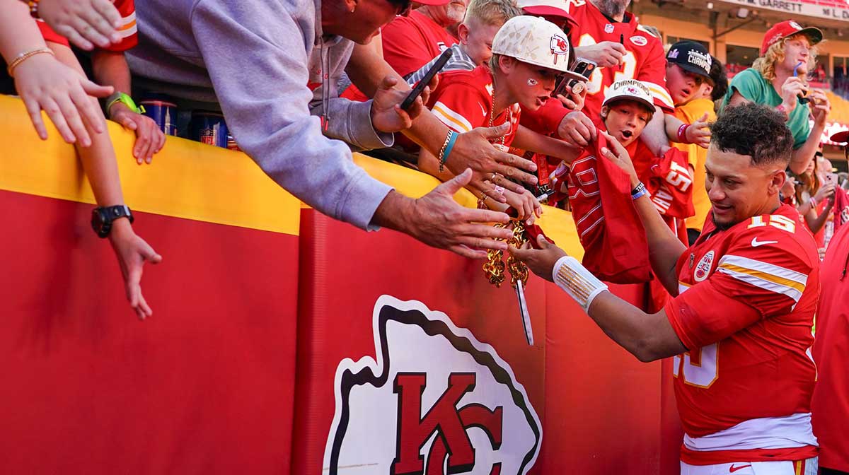 Kansas City Chiefs quarterback Patrick Mahomes (15) greets fans as he leaves the field after the game against the Las Vegas Raiders at GEHA Field at Arrowhead Stadium.