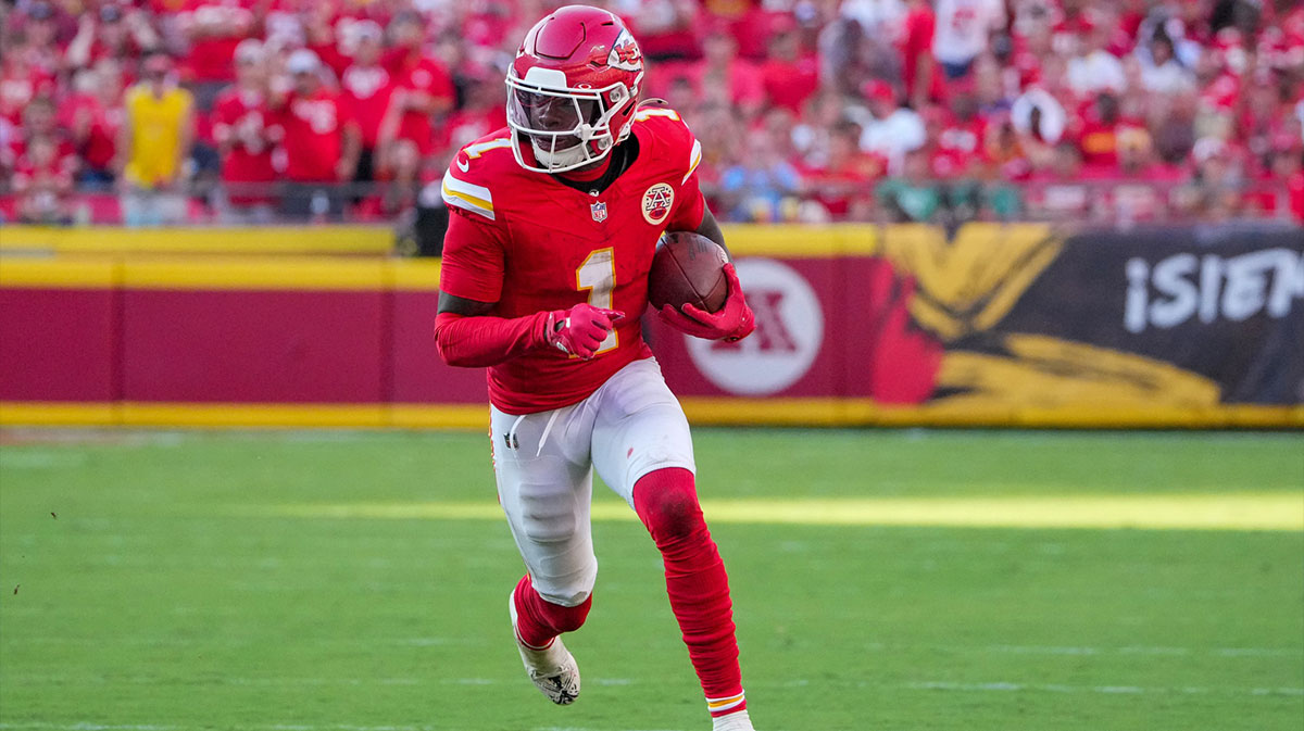 Kansas City Chiefs wide receiver Xavier Worthy (1) runs the ball against the Baltimore Ravens during the game at GEHA Field at Arrowhead Stadium.