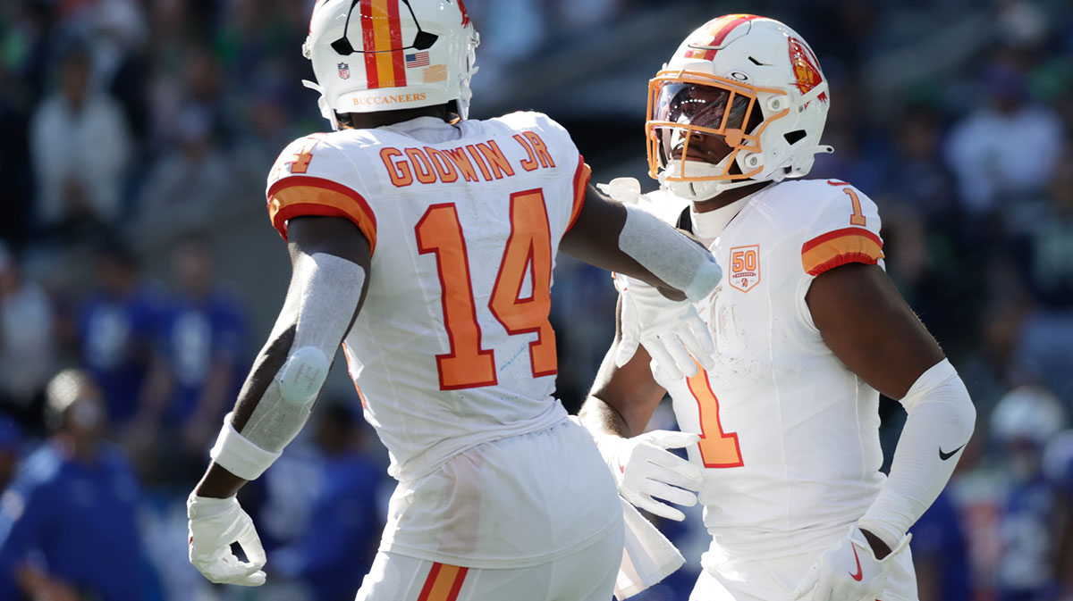 Tampa Bay Buccaneers wide receiver Chris Godwin Jr. (14) and running back Rachaad White (1) react after a first down against the Seattle Seahawks during the first half at Lumen Field.