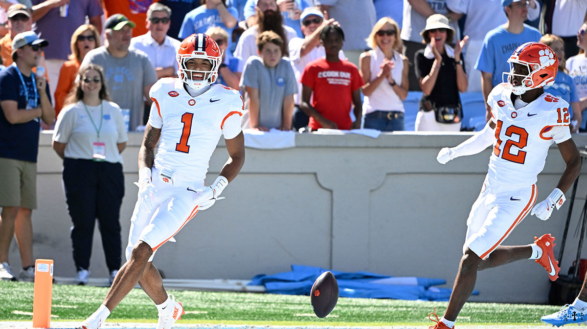 Clemson Tigers wide receiver T.J. Moore (1) celebrates with wide receiver Bryant Wesco Jr. (12) after scoring on the first play of the game at Kenan Stadium.