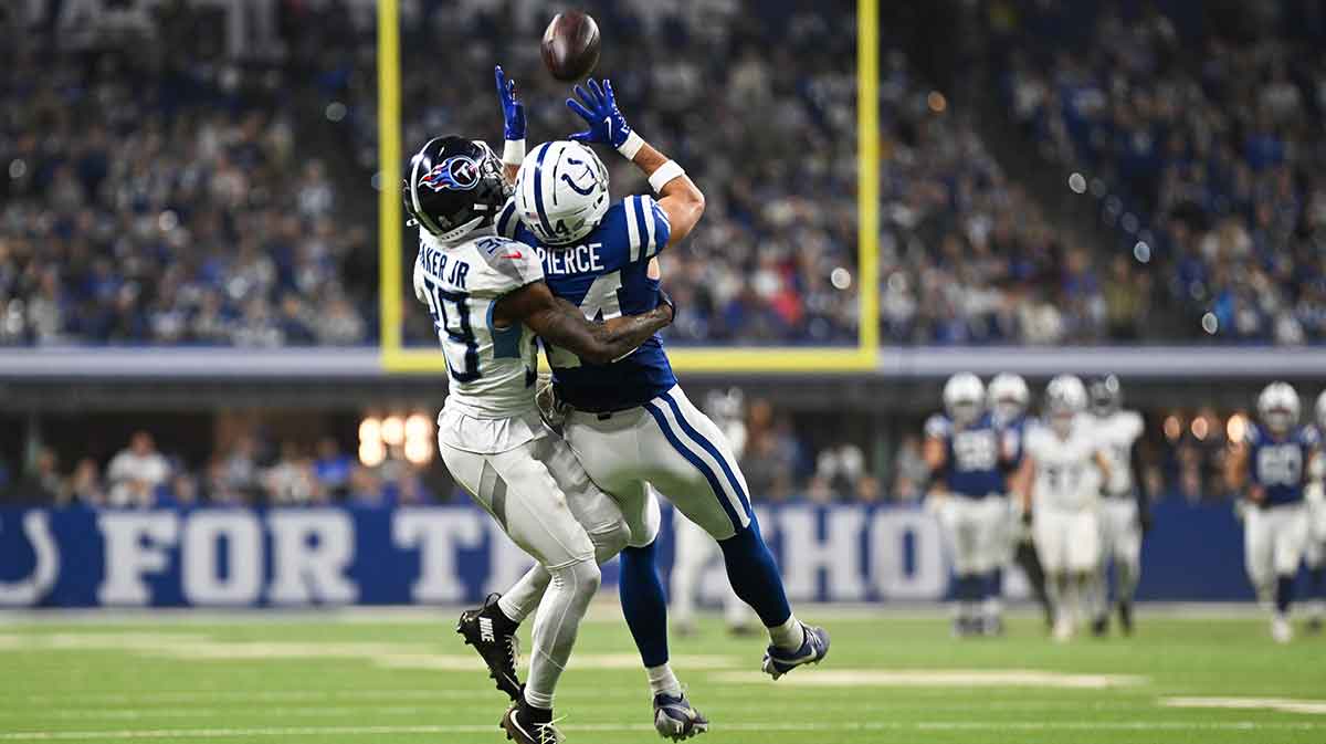 Indianapolis Colts wide receiver Alec Pierce (14) makes a catch as Tennessee Titans cornerback Darrell Baker Jr. (39) defends during the third quarter at Lucas Oil Stadium.