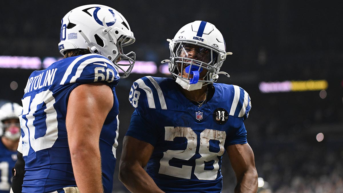 Indianapolis Colts running back Jonathan Taylor (28) celebrates with Indianapolis Colts center Tanor Bortolini (60) after scoring a touchdown during the third quarter against the Tennessee Titans at Lucas Oil Stadium.