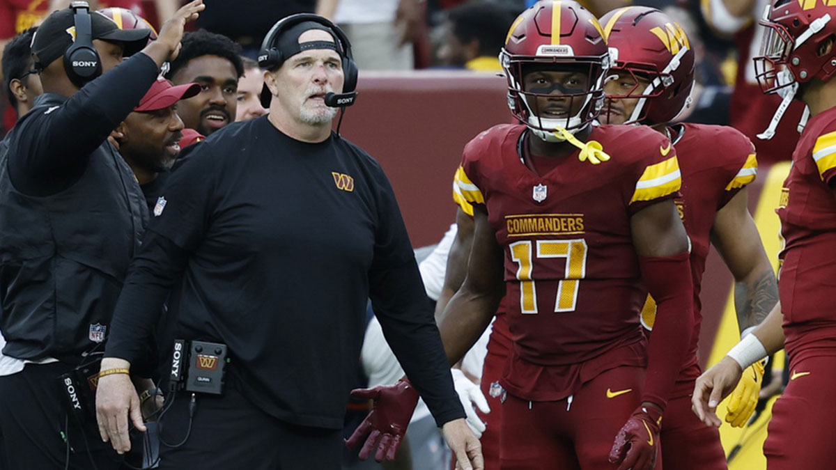 Washington Commanders head coach Dan Quinn (L) stands with Commanders wide receiver Terry McLaurin (17) on the sidelines against the Las Vegas Raiders during the third quarter at Northwest Stadium