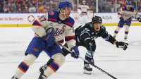 Edmonton Oilers forward Connor McDavid (97) looks to make a pass in front of Utah Mammoth forward JJ Peterka (77) during the first period at Rogers Place