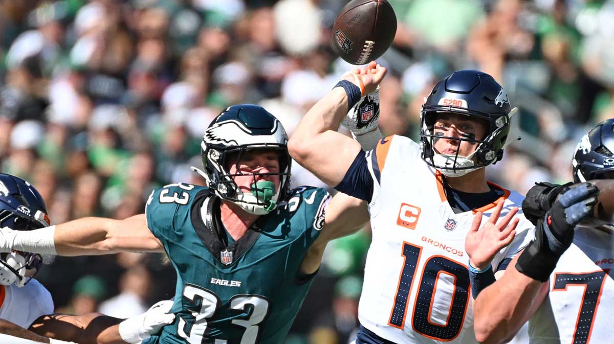 Denver Broncos quarterback Bo Nix (10) is pressured by Philadelphia Eagles cornerback Cooper Dejean (33) during the first quarter at Lincoln Financial Field.
