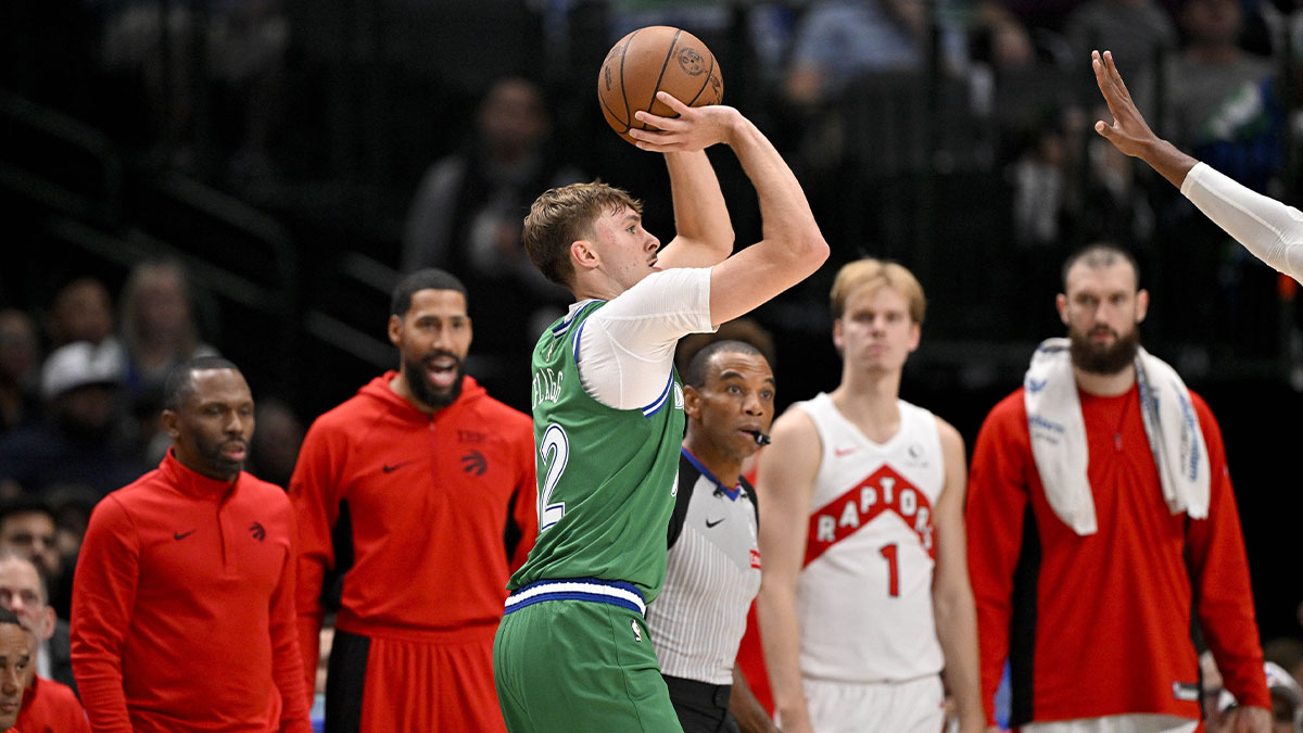 Dallas Mavericks forward Cooper Flagg (32) make a three point basket in front of the Toronto Raptors bench during the second quarter at the American Airlines Center.