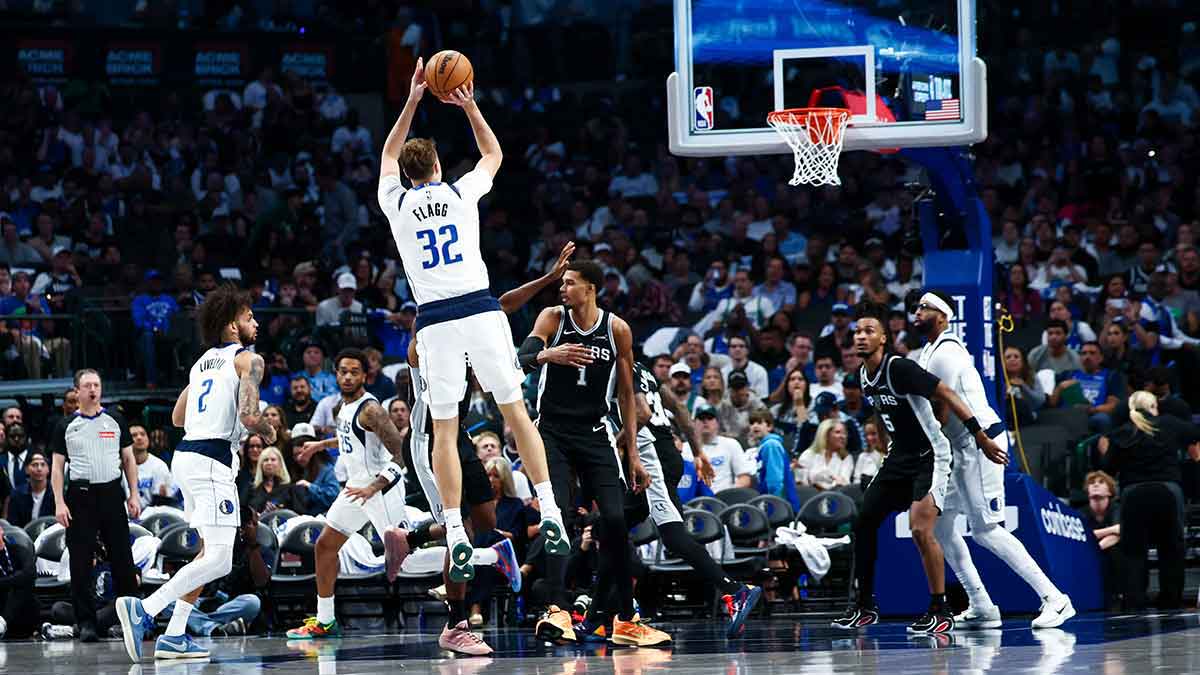 Dallas Mavericks forward Cooper Flagg (32) shoots and scores his first NBA basket during the second half against the San Antonio Spurs at American Airlines Center.