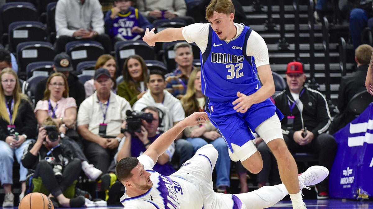 Utah Jazz center Jusuf Nurkić (30) slides for the ball against Dallas Mavericks forward Cooper Flagg (32) during the first quarter at Delta Center.